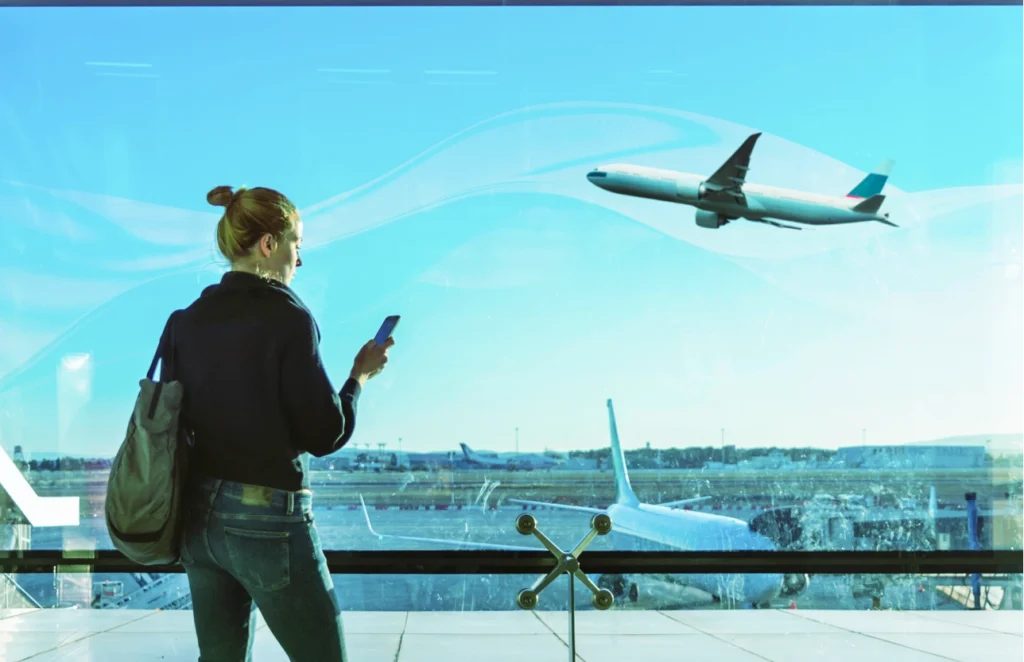 woman with phone traveling in the airport with MiFinity app